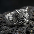 Load image into Gallery viewer, Oxidized sterling silver Oni mask ring with fierce horned demon face and engraved side motifs, macro photo on black volcanic rock
