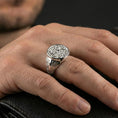 Load image into Gallery viewer, Polished silver spiral motif signet ring on the finger, wearable shot emphasizing the round face and crisp geometric side details
