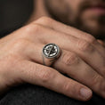 Load image into Gallery viewer, Oxidized compass signet ring worn on a finger, close-up lifestyle photo highlighting the raised wind rose star and beaded rim
