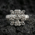 Load image into Gallery viewer, Polished silver Celtic knot cross ring featuring crisp interwoven knotwork and smooth edges, close-up product shot on volcanic stone
