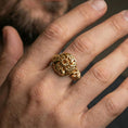 Load image into Gallery viewer, Gold plated Celtic windflower ring worn on a finger, close-up lifestyle image emphasizing the openwork flower silhouette and braided knot accents
