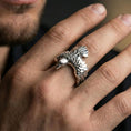 Load image into Gallery viewer, Polished silver wing wrap ring on the finger, wearable photo emphasizing the feather texture and open adjustable fit
