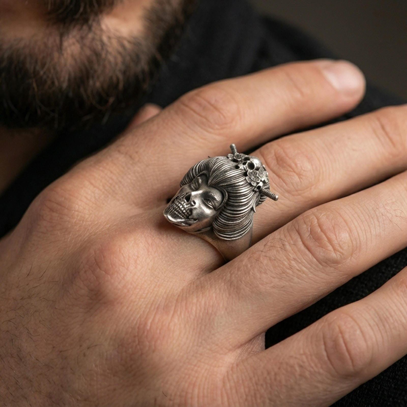 Oxidized geisha skull ring worn on a finger, lifestyle close-up highlighting the sculpted hair bun and skeletal face detail