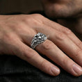 Load image into Gallery viewer, Polished silver skull ring on the finger, wearable photo emphasizing the raised crest and industrial chain texture

