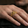 Load image into Gallery viewer, Gold plated crowned skull ring worn on a finger, close-up lifestyle image showing the bold skull face and spike crown silhouette
