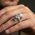Load image into Gallery viewer, Polished silver tree bark skull ring on the finger, wearable close-up showing detailed texture carving and bold skull profile
