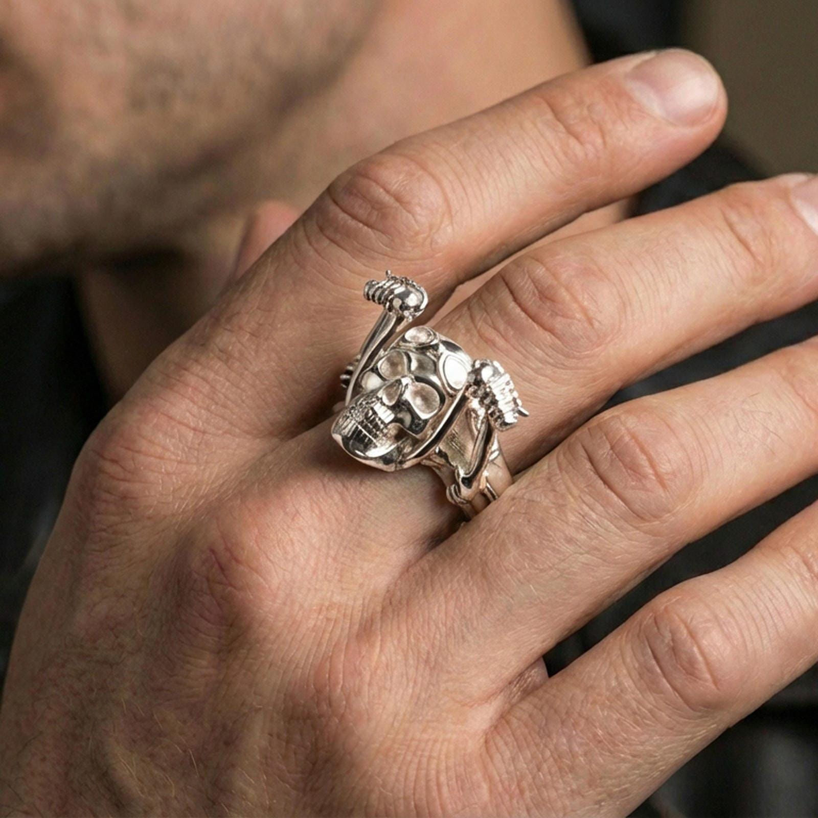 Polished silver aviator skull ring on the finger, wearable close-up showing gothic biker styling and sculpted skull depth