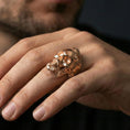 Load image into Gallery viewer, Rose gold plated skull ring worn on a finger, lifestyle shot focusing on the bearded skull profile and strong gothic look

