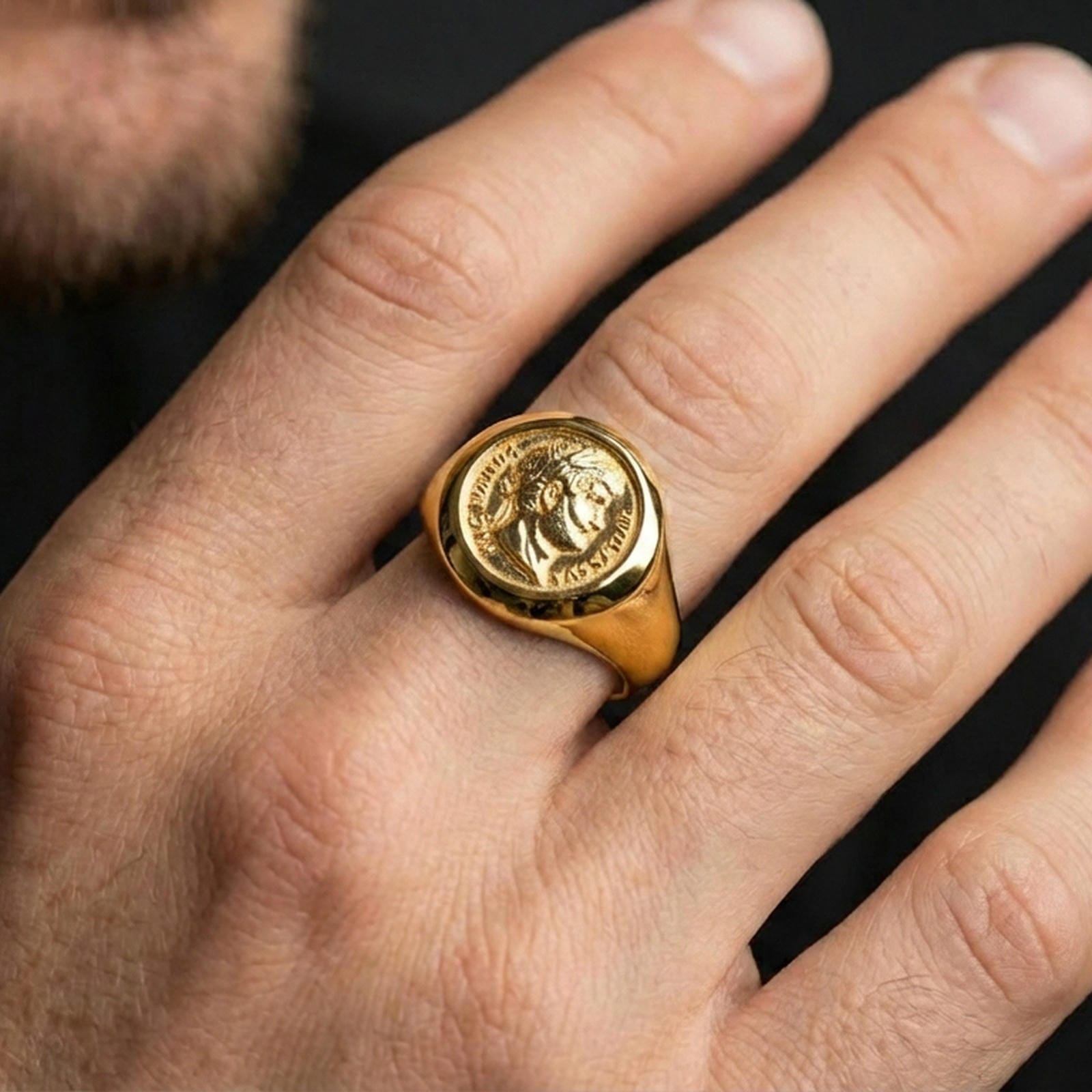 Gold plated ancient Roman coin ring worn on a finger, lifestyle close-up emphasizing the emperor profile and engraved lettering