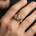 Load image into Gallery viewer, Rose gold plated Roman coin ring worn on a finger, close-up lifestyle image showing the Augustus portrait and antique coin detail
