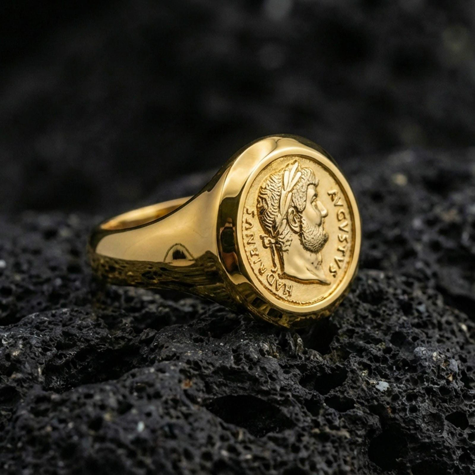 Gold plated Roman coin ring with Augustus emperor profile and crisp Latin inscription, product-only macro on black volcanic rock