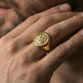 Load image into Gallery viewer, Gold plated coin portrait ring worn on a finger, lifestyle close-up emphasizing the engraved crowned profile
