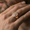 Load image into Gallery viewer, Rose gold plated ancient coin signet ring on the finger, close-up lifestyle image showing the portrait relief and metal texture
