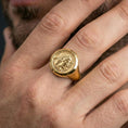 Load image into Gallery viewer, Gold plated Greek coin signet ring worn on a finger, lifestyle close-up emphasizing the coin face and bold vintage style
