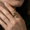 Load image into Gallery viewer, Gold plated heart dagger ring worn on a finger, lifestyle close-up emphasizing the romantic heart motifs and edgy dagger shape
