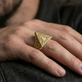 Load image into Gallery viewer, Gold plated illuminati triangle signet ring worn on a finger, lifestyle close-up showing the eye motif and bold statement look
