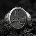 Load image into Gallery viewer, Oxidized sterling silver oval signet ring with engraved demonic sigil symbol and textured background, macro shot on black volcanic rock
