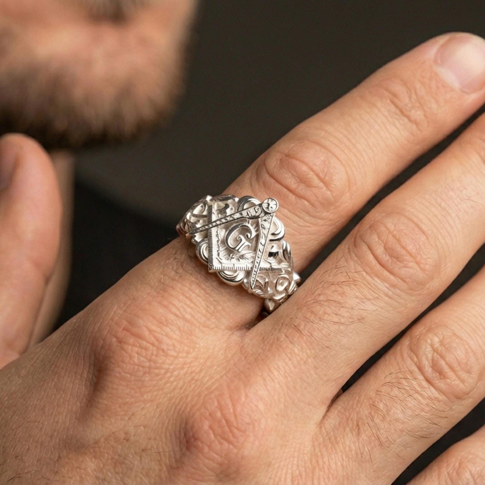 Polished silver Freemason ring on the finger, wearable close-up showing the raised “G” and engraved band details