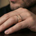 Load image into Gallery viewer, Rose gold plated serpent skin ring worn on finger, sculpted snake scale texture with clean borders, elegant lifestyle wear shot.
