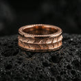 Load image into Gallery viewer, Rose gold plated sterling silver snake scale band on volcanic stone, intricate reptile texture with strong contrast, minimal high-end close-up.
