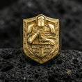 Load image into Gallery viewer, Sterling silver knight signet ring with a gold plated finish, shield crest with armored warrior holding a sword, detailed engraving on black volcanic rock
