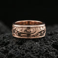 Load image into Gallery viewer, Rose gold plated sterling silver spinner cloud band on volcanic stone, playful swirl relief with floral accents and deep contrast, minimal high-end close-up.
