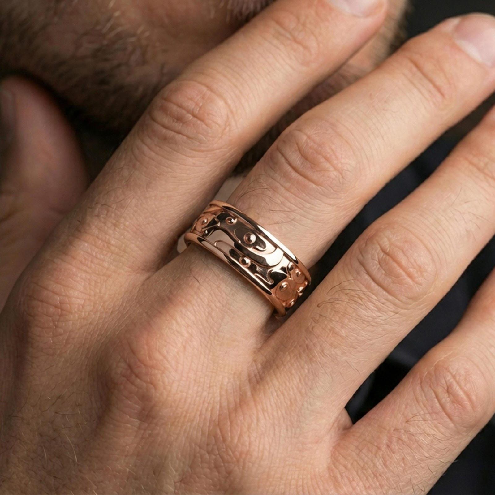Rose gold plated spinner cloud band ring worn on finger, playful swirl relief with floral accents, elegant lifestyle wear shot.