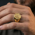 Load image into Gallery viewer, Gold plated finish Valknut signet ring worn on a finger, close-up lifestyle photo focusing on the Norse Valknut symbol and bold signet profile
