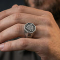 Load image into Gallery viewer, Oxidized finish Valknut signet ring worn on a finger, octagon face with Norse triple triangle symbol shown in a close-up lifestyle shot

