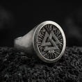 Load image into Gallery viewer, Sterling silver Valknut signet ring with an oxidized finish, round face featuring a Norse triple-triangle symbol over a branch-like texture, macro on black volcanic rock
