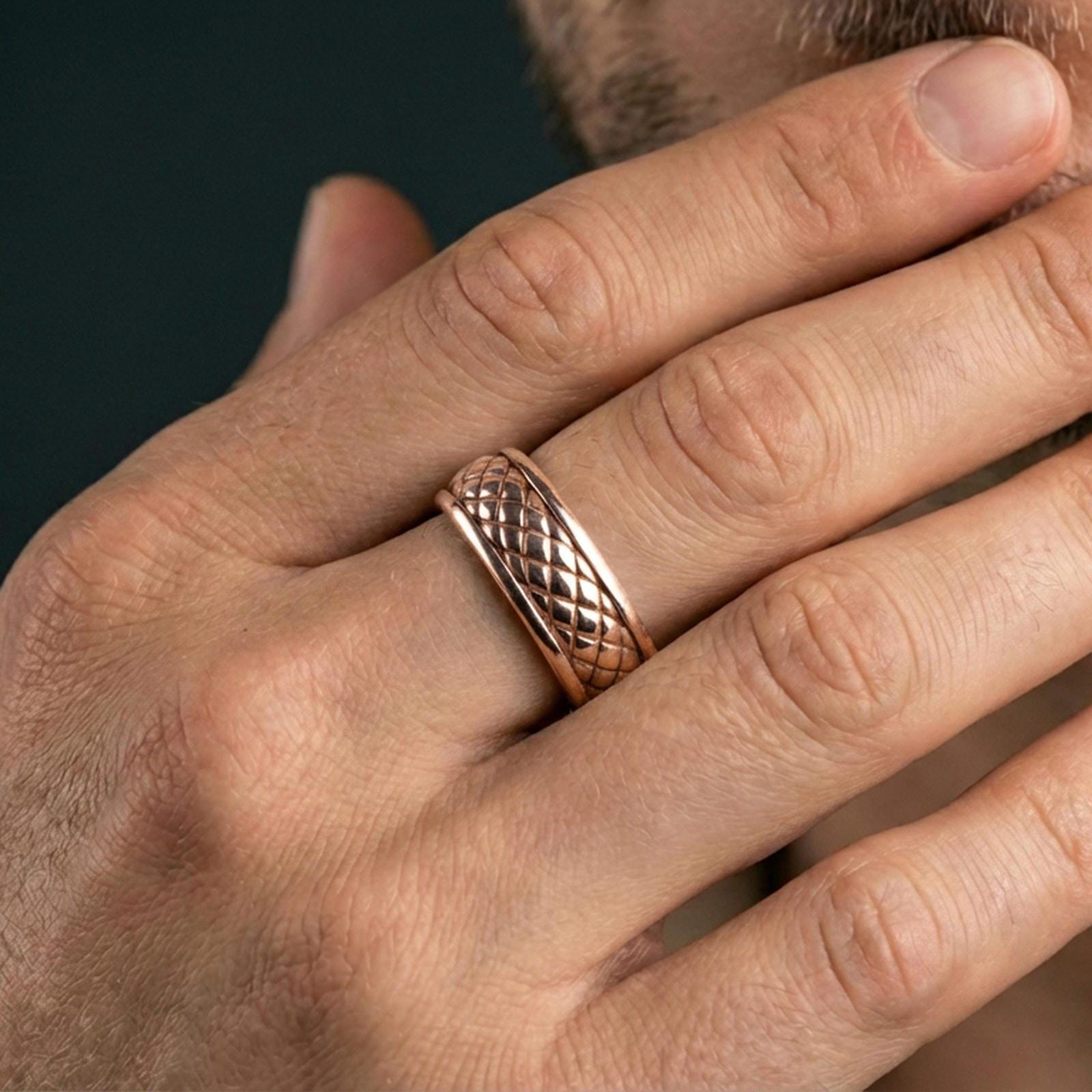 Rose gold plated quilted band ring worn on finger, sculpted diamond grid texture detail, elegant lifestyle wear shot.
