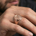 Load image into Gallery viewer, Rose gold plated finish US eagle seal signet ring on the finger, macro lifestyle shot showcasing the detailed crest engraving and strong masculine silhouette
