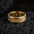 Load image into Gallery viewer, Gold plated beaded dot pattern band ring on volcanic rock, detailed bubble texture with rope edge trim, luxury jewelry product photography.
