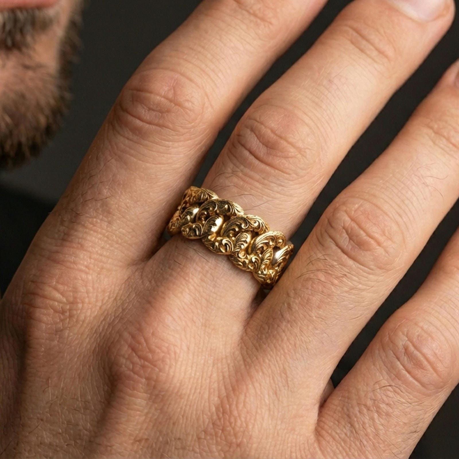 Gold plated Cuban link chain ring worn on finger, detailed sculpted links and engraved pattern, premium lifestyle jewelry photo.