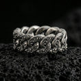 Load image into Gallery viewer, Oxidized sterling silver Cuban link chain ring on dark volcanic rock, engraved scrollwork on each link, premium macro product shot.
