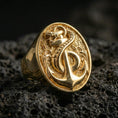 Load image into Gallery viewer, Sterling silver anchor and snake signet ring with a gold plated finish, bold maritime anchor design wrapped by serpent, macro on volcanic rock

