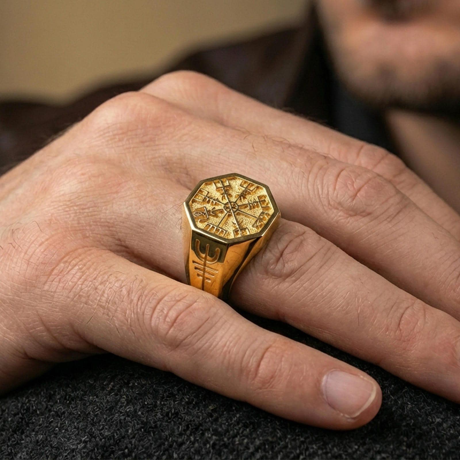 Gold plated finish sterling silver Vegvisir signet ring worn on a finger, close-up lifestyle photo emphasizing the runic compass and shine