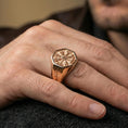 Load image into Gallery viewer, Rose gold plated finish Vegvisir signet ring on a finger, macro lifestyle shot focusing on the octagonal signet and Nordic symbolism
