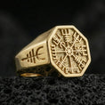 Load image into Gallery viewer, Sterling silver Vegvisir signet ring with a gold plated finish, Viking runic compass design on an octagonal face, macro on volcanic rock
