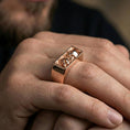 Load image into Gallery viewer, Rose gold plated finish rectangular signet ring on a finger, macro lifestyle shot showcasing the rectangular cutout design and sculpted accents
