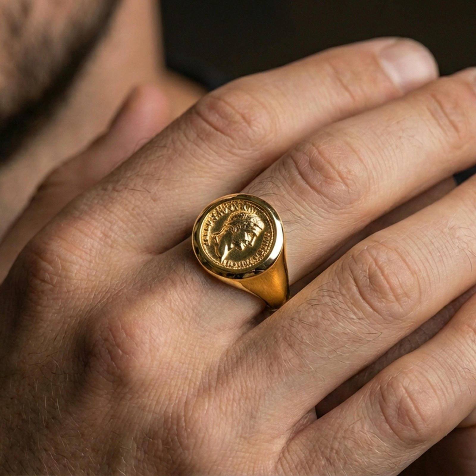 Gold plated finish sterling silver Roman coin signet ring worn on a finger, close-up lifestyle photo emphasizing the coin relief and heritage styling