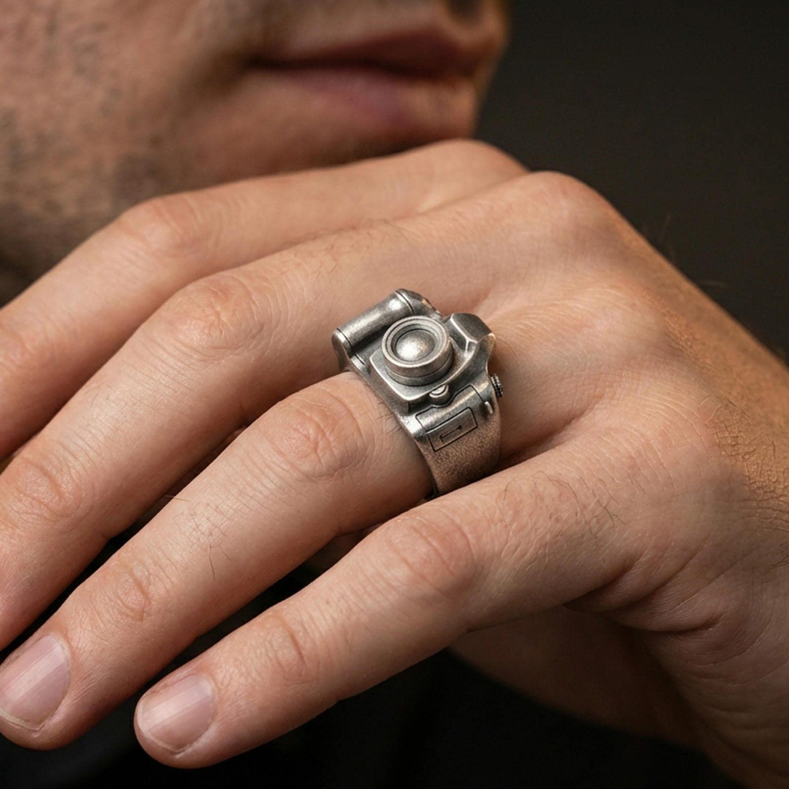 Oxidized finish sterling silver camera signet ring worn on a finger, close-up lifestyle shot highlighting the 3D lens and vintage patina