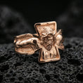 Load image into Gallery viewer, Rose gold plated crucifix Jesus ring on volcanic stone, sculpted Christ figure with deep contrast and sharp cross outline, minimal high-end close-up.
