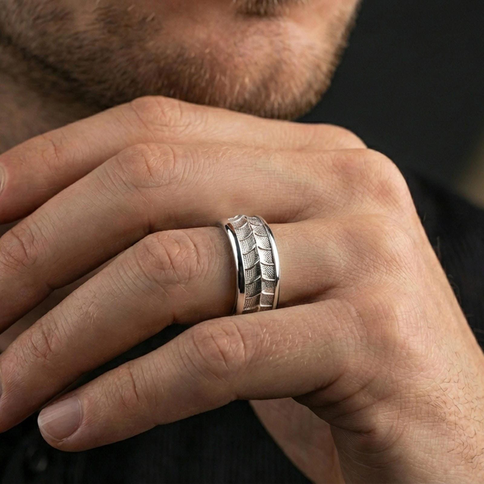 Polished silver lizard scale fidget spinner ring on finger, crisp reptile texture detail and smooth edges, refined everyday wear close-up.