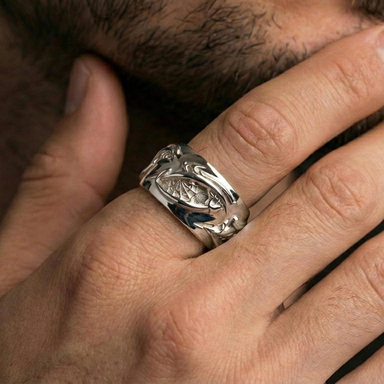 Polished silver nature-inspired roots ring on finger, crisp twisted vine engraving with textured interior, refined everyday wear close-up.