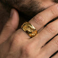 Load image into Gallery viewer, Gold plated roots wedding band worn on finger, detailed organic vine relief with rugged texture, premium lifestyle jewelry photo.
