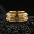 Load image into Gallery viewer, Gold plated elven star spinner band ring on volcanic rock, detailed Celtic knotwork and star motif on rotating band, luxury jewelry product photography.
