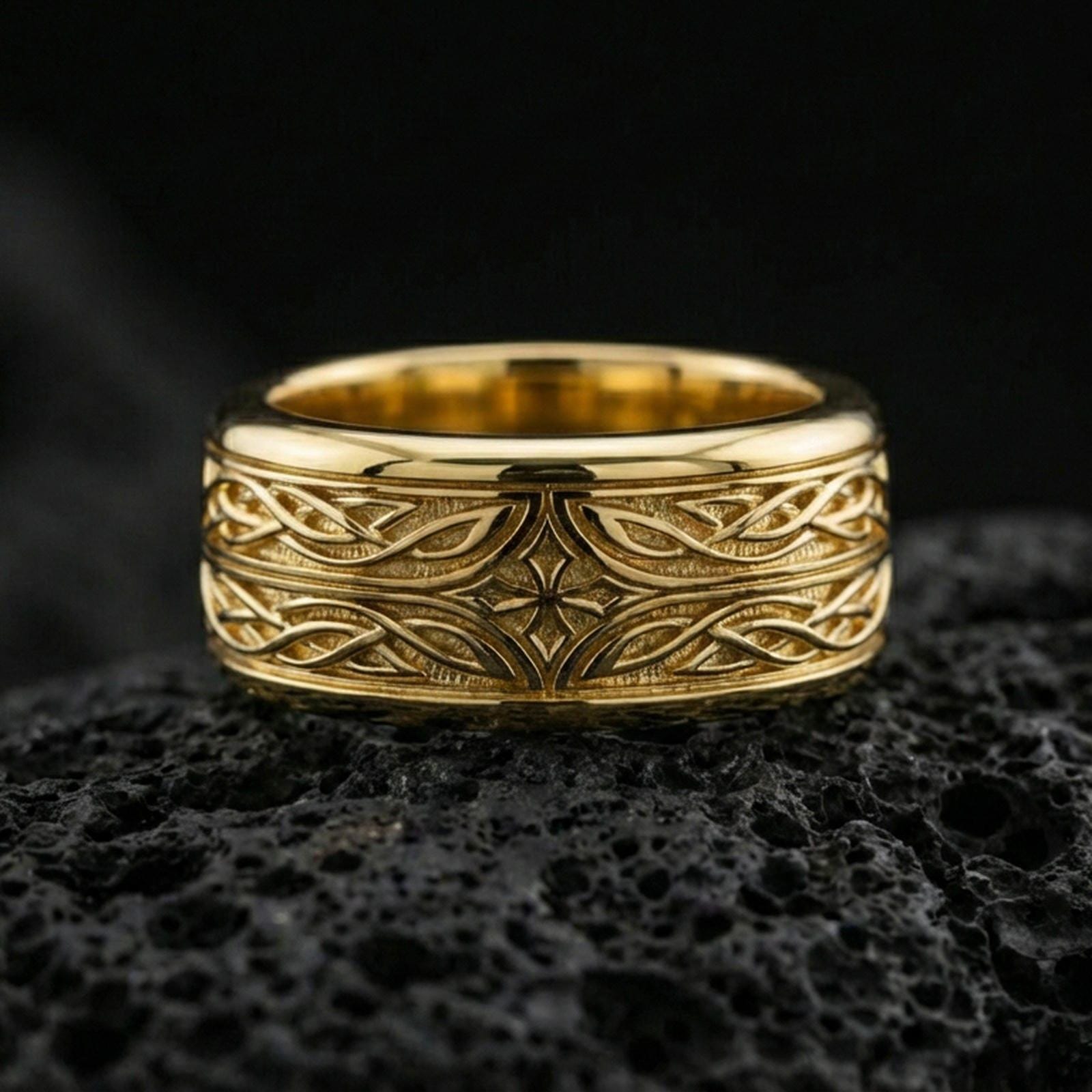 Gold plated elven star spinner band ring on volcanic rock, detailed Celtic knotwork and star motif on rotating band, luxury jewelry product photography.