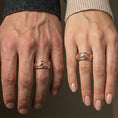 Load image into Gallery viewer, Rose gold plated koi fish spinner ring worn on finger, sculpted koi and wave relief detail, elegant lifestyle wear shot.
