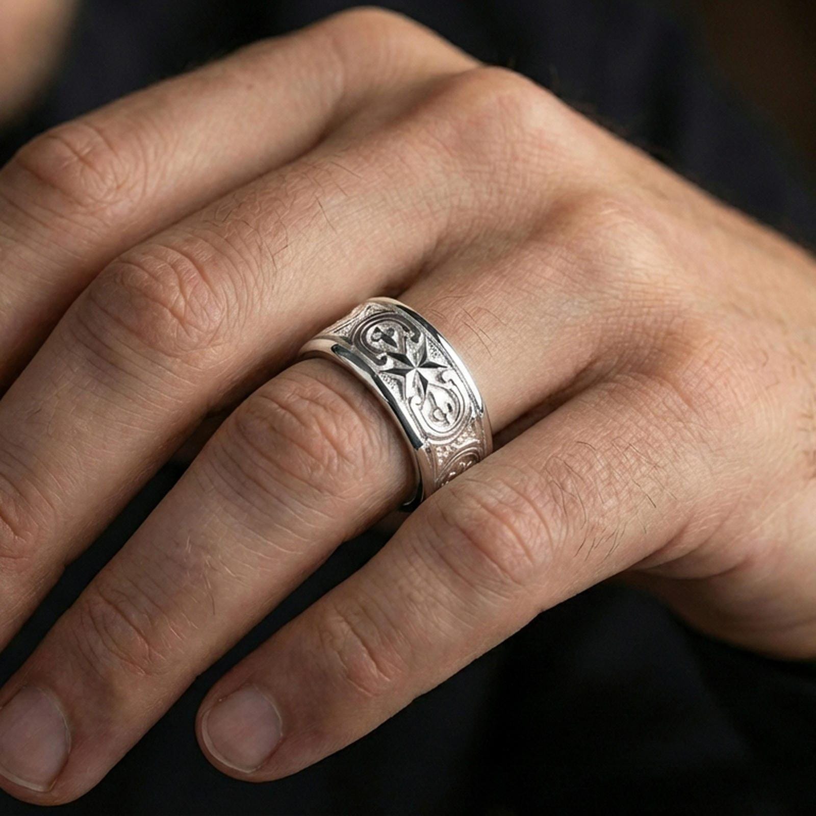 Polished silver Maltese cross fidget spinner ring on finger, crisp cross relief with ornate panel detail, refined everyday wear close-up.